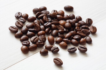 Poster - Pile coffee beans on white  wooden texture background