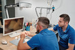 Dental technicians producing dental prosthesis under the microscope.