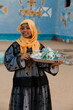 A Nubian girl carrying a teapot