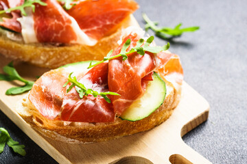 Sticker - Open sandwiches with cream cheese, prosciutto, cucumber and arugula.