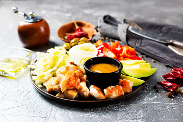 Wall Mural - Cobb salad with sauce. Traditional american dish made of salad leaves, avocado, cherry tomatoes, fried chicken and spices