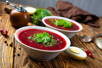 Wall Mural - Traditional Ukrainian Russian borscht . Bowl of red beet root soup borsch with white cream . Beet Root delicious soup . Traditional Ukrainian food cuisine