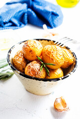 Wall Mural - baked potatoes whole in their skins with rosemary and garlic