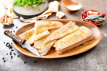 Poster - Fresh raw fish fillet with spices, pepper, salt, basil on a stone plate, top view, square