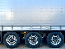 Semi-trailer Curtain Of Gray Color For The Transportation Of A Large Number Of Goods. Tent Tension Lock And Three Wheels
