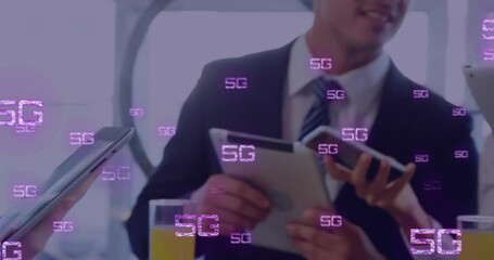 Poster - Animation of 5g texts over caucasian business people using smartphone
