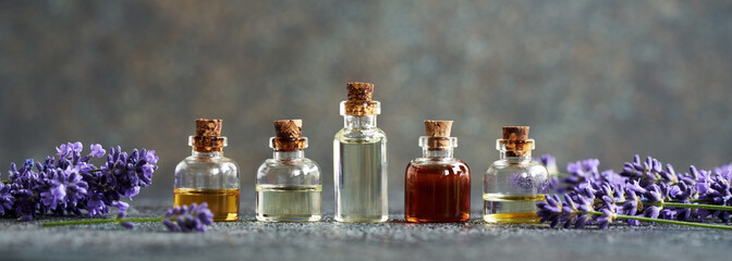 Banner with essential oil bottles with lavender flowers