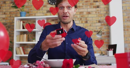 Poster - Animation of red heart icons over caucasian man holding engagement ring