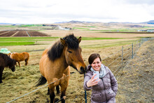 Woman Taking Selfie With Horse On Farm