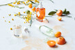 © Cavan Images - Still life display of skin care products with fruits and branches