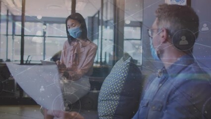 Canvas Print - Animation of network of connections over diverse business people wearing face masks at office