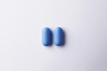 Wall Mural - Pills on white background, top view. Potency problem