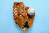 Fototapeta Kawa jest smaczna - Catcher's mitt and baseball ball on light blue background, top view. Sports game