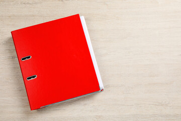 Red office folder on white wooden table, top view. Space for text