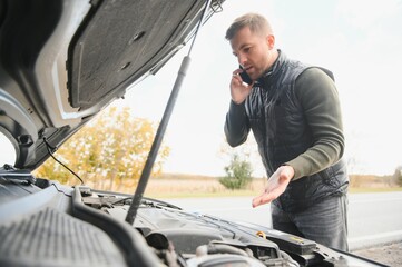 Wall Mural - driver trying to figure out how to fix broken down car with red triangle to warn other road users