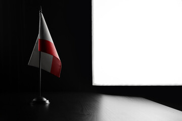 Small national flag of the Gibraltar on a black background