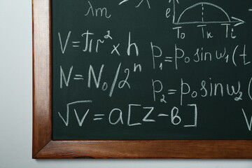 Wall Mural - Chalkboard with many different math formulas on white wall, closeup