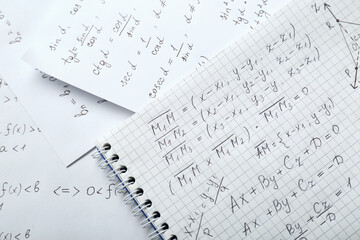 Sheets of paper with different mathematical formulas, top view
