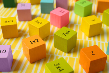 Wall Mural - Colorful cubes with numbers and multiplications on yellow background