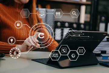 Wall Mural - Copyright or patent concept, Business team analyzing data and using smart phone and tablet with virtual screen copyright icon trademark license, Creation ownership against piracy.