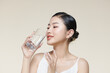 pretty young woman drinking water from glass
