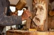 Leinwandbild Motiv close up of hand carving wood spirit sculpture by skillful artisan wood worker 