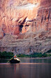 © Cavan Images - A river guide rowing a wooden dory downstream, Grand Canyon National Park, Arizona.