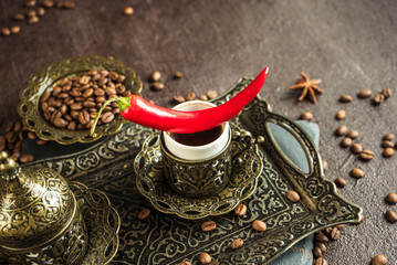 Wall Mural - traditional turkish coffee in vintage cup, anise, roasted beans with hot spicy chili pepper on brown background 9