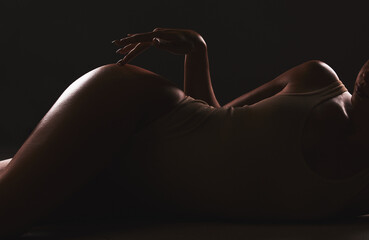 lingerie, shadow and silhouette of sexy woman relax in erotic, sexual and seductive underwear on dar