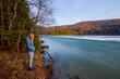 © czamfir - a woman sitting and looking towards a lake