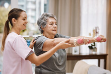 Women, Senior Or Physiotherapy Help With Dumbbell In Wellness Clinic, Healthcare Center Or Nursing Home Living Room. Smile, Happy Or Physiotherapist Nurse And Elderly Patient In Weight Rehabilitation