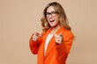 © ViDi Studio - Young successful employee business woman corporate lawyer 30s wear formal orange suit glasses work in office point index finger camera on you motivating encourage isolated on plain beige background.