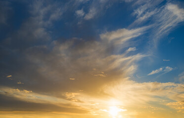 Wall Mural - sunset scenery blue sky and yellow shiny sinking sun