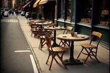 A Row Of Tables And Chairs On The Side Of A Street Next To A Sidewalk With People Walking On The Sidewalk In The Distance And A Row Of Tables And A Row Of Chairs On The Sidewalk. Generative AI