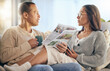 Senior couple, newspaper and relax talking on sofa reading, morning conversation or quality time bonding together in living room. Elderly man, woman and news discussion, coffee and retirement peace