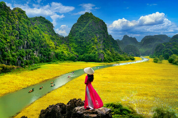 Asian woman wearing Vietnam culture traditional at Tam coc, Vietnam.