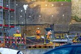 Fototapeta  - Construction site at Swiss City of Biel Bienne with wall in the background on a sunny autumn day. Phot taken November 10th, 2022, Biel Bienne, Switzerland.
