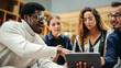 © Gorodenkoff - Multiethnic Young Group of People Brainstorming Together in a Meeting Room at the Office. Black Male E-commerce Coordinator Pitching His Ideas To Startup Management Board Members Using Tablet