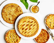 Apple And Peach Pies On Plates