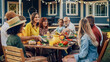 © Gorodenkoff - Group of Multiethnic Diverse People Having Fun, Communicating with Each Other and Eating Vegetarian Meals at an Outdoors Dinner. Relatives and Friends Gathered Outside Their Home on Warm Summer Day.
