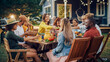© Gorodenkoff - Family and Multiethnic Diverse Friends Gathering Together at a Garden Table. People Eating Grilled and Fresh Vegetables, Sharing Tasty Salads for a Big Family Celebration with Relatives.