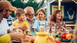 © Gorodenkoff - Portrait of a Happy Senior Grandfather Holding His Bright Talented Little Grandchildren on Lap at a Outdoors Dinner Party with Food and Drinks. Family Having a Picnic Together with Children.