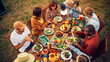 © Gorodenkoff - Top Down Elevated View at a Family and Friends Celebrating Outside at Home. Diverse Group of Children, Adults and Seniors Sitting at a Table, Having Fun Conversations. Eating Barbecue and Vegetables.