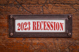 Fototapeta Kawa jest smaczna - 2023 recession  - a label on grunge wooden file cabinet. Bear market and financial crisis