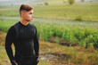 © Viorel - the handsome sportsman dressed in a sports suit admires the beauty of a field before starting his morning training