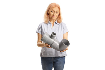 Confused woman looking at a plastic water pipe