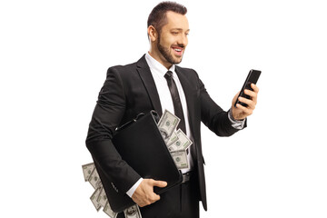 Sticker - Young rich businessman holding a suitcase with money and a smartphone