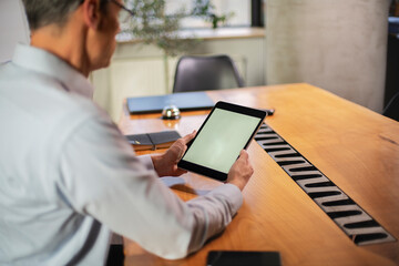 Close up of man using digital tablet.