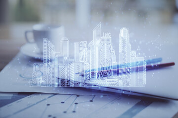 Canvas Print - Desktop computer background in office and big town buildings hologram drawing. Double exposure. Smart city concept.