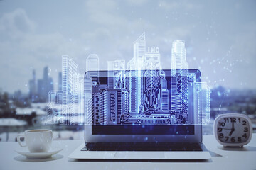 Poster - Desktop computer background in office and big town buildings hologram drawing. Double exposure. Smart city concept.